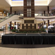 Illustration for article titled Entire Shopping Mall Quietly Dreading Whatever Empty Stage Set Up For